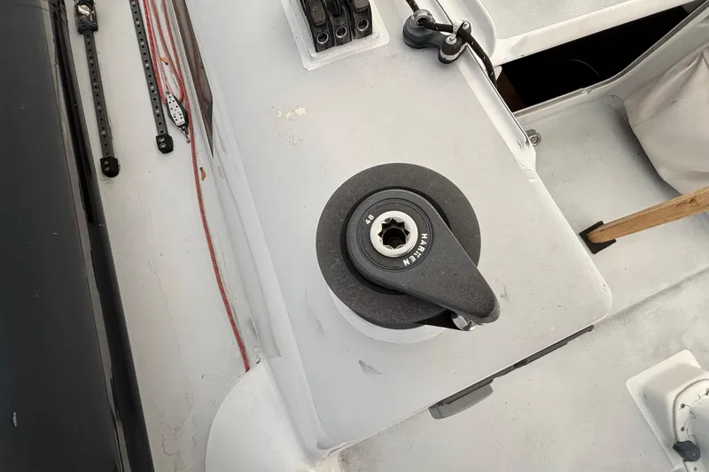 Slide: The Image of Winch on a 1995 Tripp 47 sailboat deck, featuring ropes and hardware. - 44