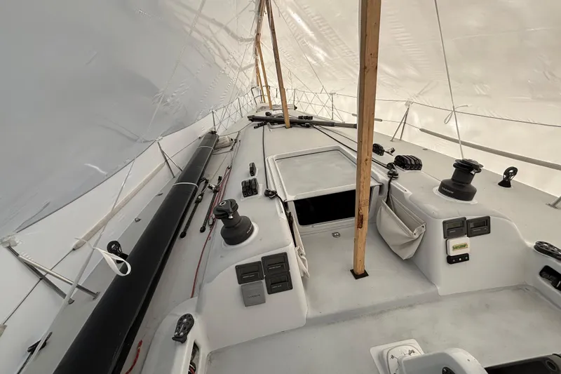 Slide: The Image of Sailboat deck under cover, Tripp 47 model, 1995, featuring winches and rigging. - 47