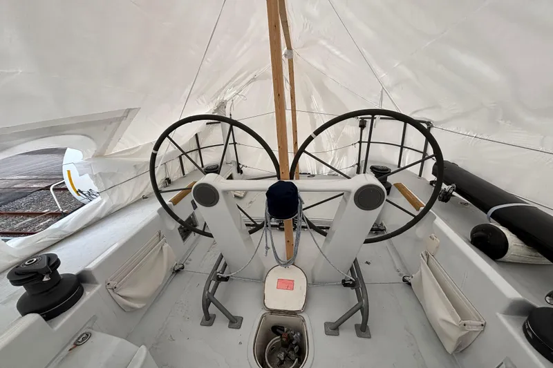 Slide: The Image of Dual steering wheels on a 1995 Tripp 47 sailboat under a protective cover. - 48