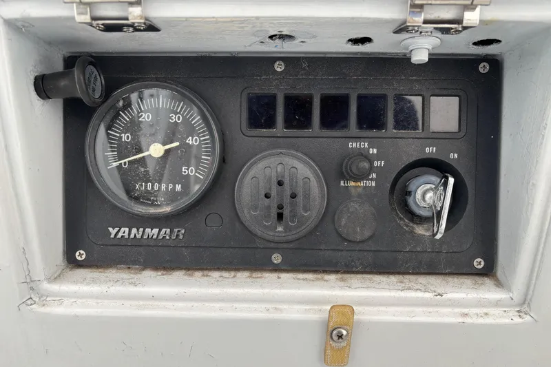 Slide: The Image of Control panel of a 1995 Tripp 47 with Yanmar tachometer and ignition switch. - 53