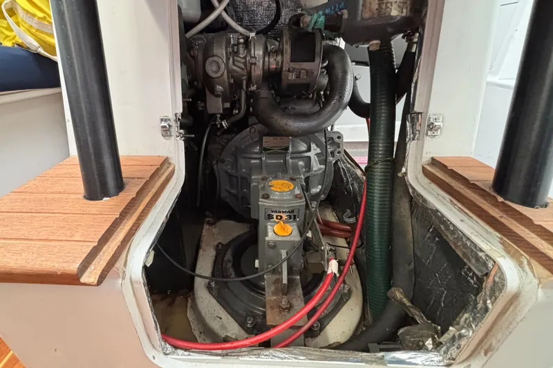 Slide: The Image of Engine compartment of a 1995 Tripp 47 sailboat, featuring a Yanmar engine. - 54
