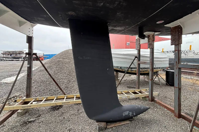 Slide: The Image of Keel of a 1995 Tripp 47 sailboat in a boatyard setting. - 58