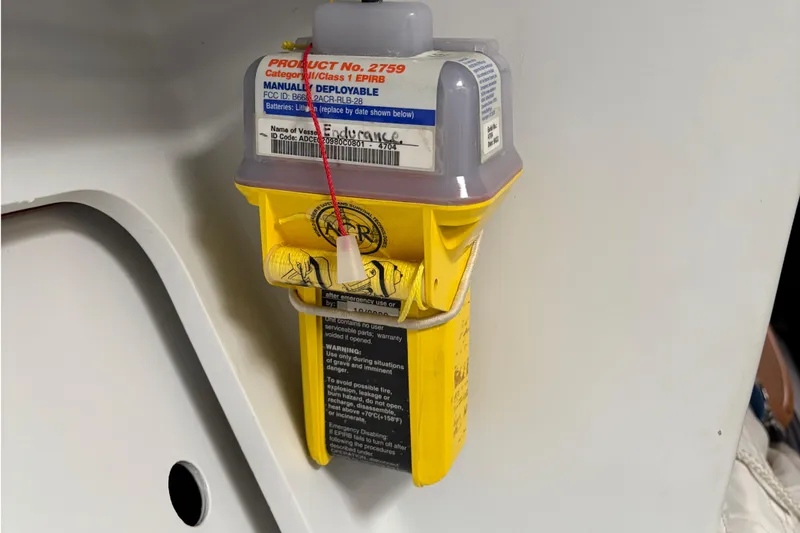 Slide: The Image of Manual deployable EPIRB device on Tripp 47, 1995 model, mounted on a white surface. - 59