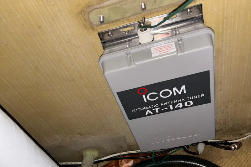 Slide: The Image of Icom AT-140 automatic antenna tuner mounted on a Tripp 47, 1995 model. - 60