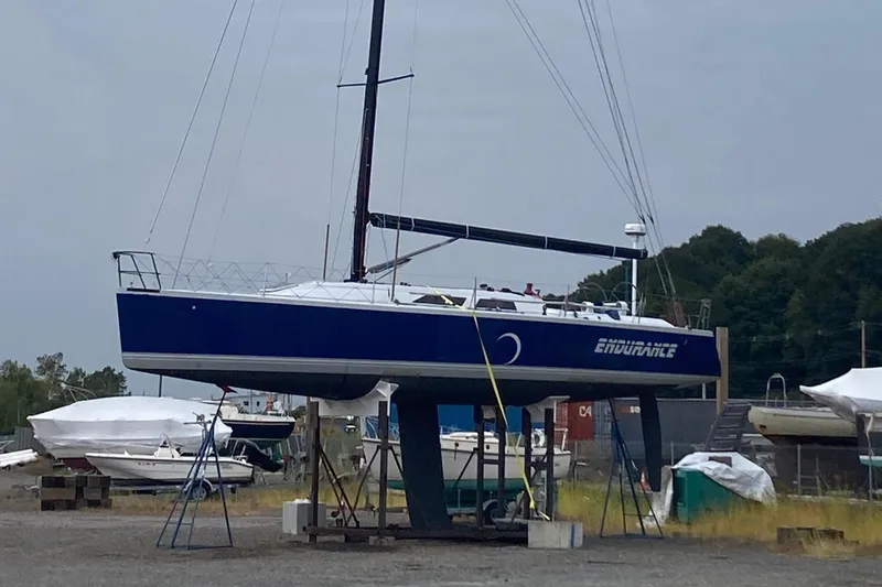 Slide: The Image of Sailboat "Endurance" on land, Tripp 47 model, 1995, in a boatyard setting. - 8