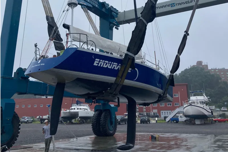 Slide: The Image of Sailboat "Endurance" being lifted by crane at a marina, Tripp 47 model, 1995. - 9