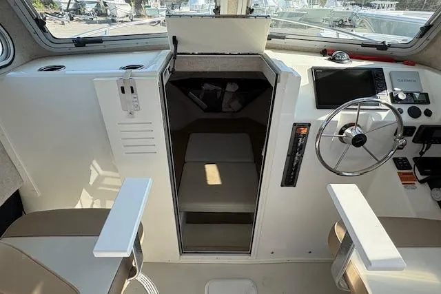 Slide: The Image of 2019 Parker 2520 XLD Sport Cabin interior with steering wheel and navigation equipment. - 14