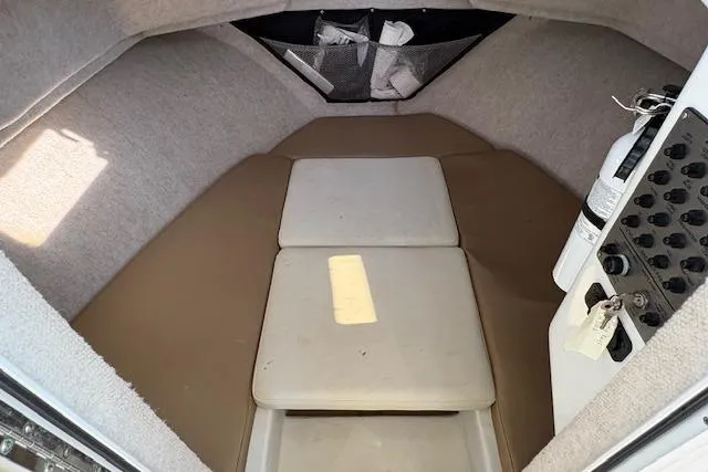 Slide: The Image of 2019 Parker 2520 XLD Sport Cabin interior with cushioned seating and storage. - 15
