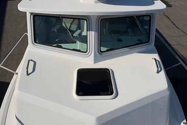 Slide: The Image of 2019 Parker 2520 XLD Sport Cabin boat, front view with windows and hatch. - 23
