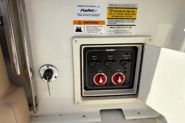 Slide: The Image of 2019 Parker 2520 XLD Sport Cabin control panel with capacity and warning labels. - 25