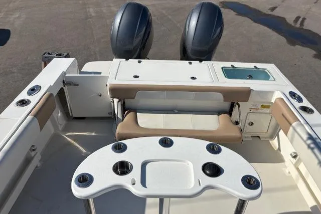 Slide: The Image of 2019 Parker 2520 XLD Sport Cabin boat interior with seating and dual engines. - 27