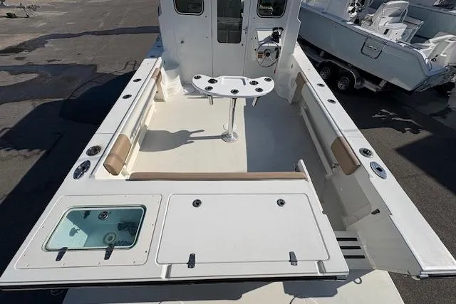 Slide: The Image of 2019 Parker 2520 XLD Sport Cabin boat interior with seating and fishing setup. - 5