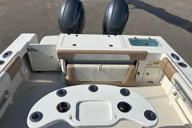 Slide: The Image of 2019 Parker 2520 XLD Sport Cabin boat interior with dual engines and fishing rod holders. - 7