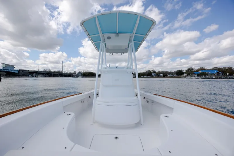 Slide: The Image of 2017 Chaos 21 Tarpon Bay boat on water under cloudy sky. - 15