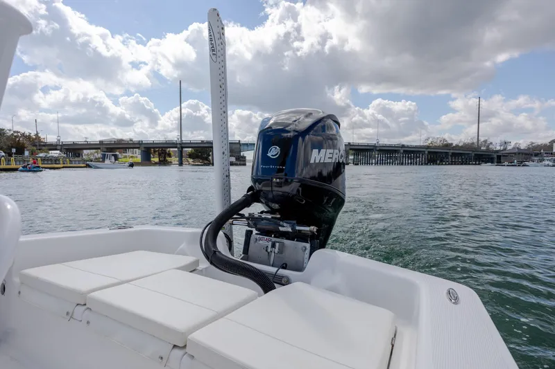 Slide: The Image of 2017 Chaos 21 Tarpon Bay boat with Mercury engine on water, bridge in background. - 17