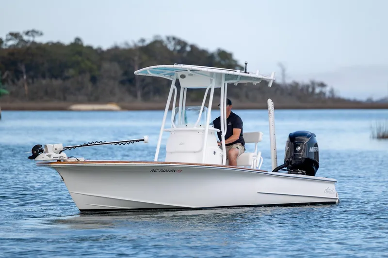 Slide: The Image of 2017 Chaos 21 Tarpon Bay boat on calm water, featuring a sleek design and powerful engine. - 4