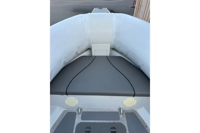 Slide: The Image of 2020 Sealegs 9m Amphibious RIB interior seating area with gray cushions. - 12