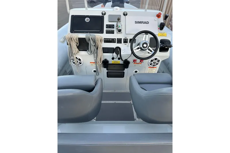 Slide: The Image of 2020 Sealegs 9m Amphibious RIB dashboard with steering wheel and navigation equipment. - 15