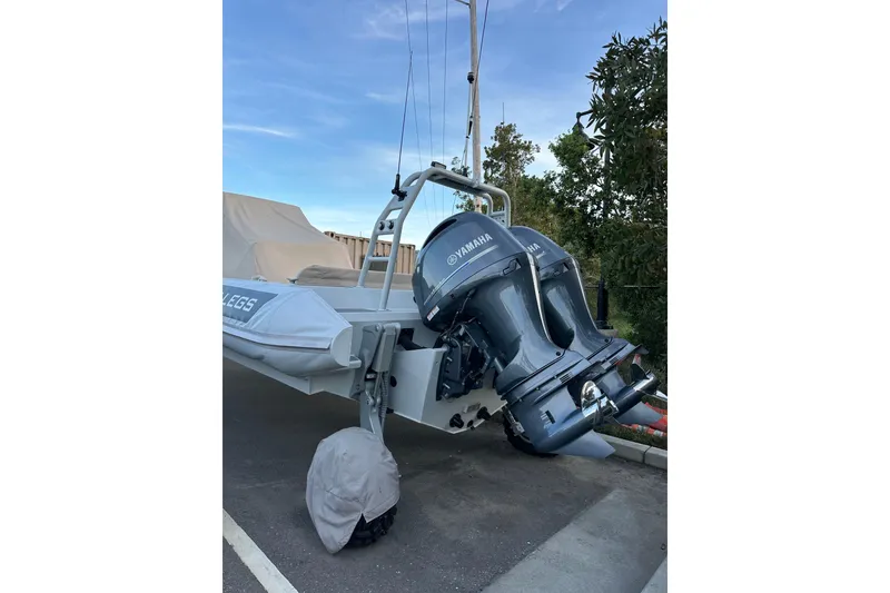 Slide: The Image of 2020 Sealegs 9m Amphibious RIB with Yamaha engines, parked on pavement. - 9