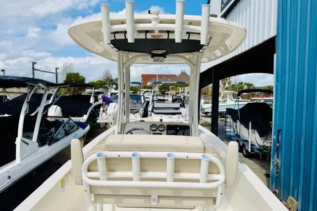 Slide: The Image of 2026 Boston Whaler 250 Dauntless boat docked, featuring center console and rod holders. - 6