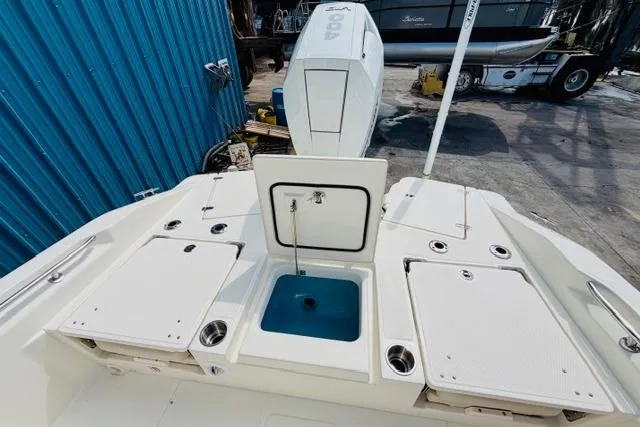 Slide: The Image of 2026 Boston Whaler 250 Dauntless boat deck with storage compartments and motor. - 7