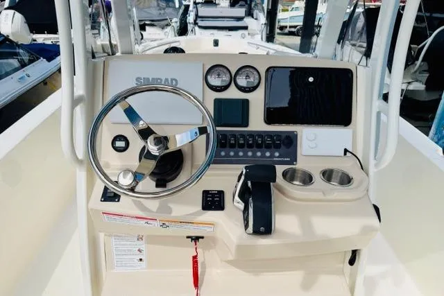 Slide: The Image of 2026 Boston Whaler 250 Dauntless boat console with steering wheel and controls. - 9