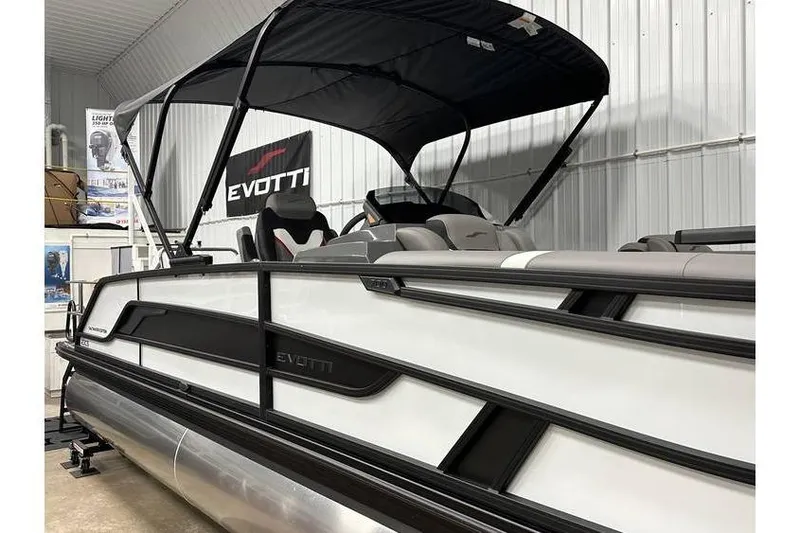 Slide: The Image of 2026 Evotti 723CS pontoon boat with canopy in showroom setting. - 14