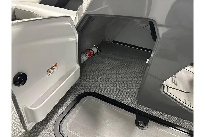 Slide: The Image of Open storage compartment in 2026 Evotti 723CS boat with fire extinguisher inside. - 23