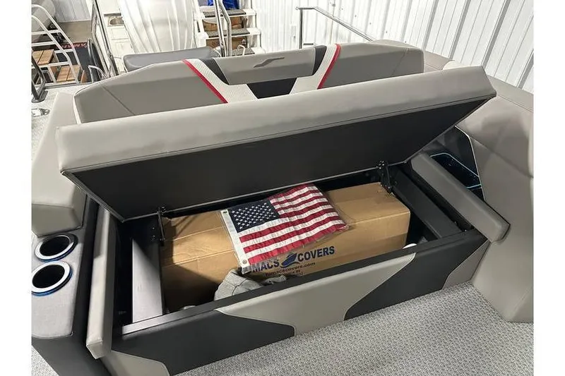 Slide: The Image of Open storage compartment in 2026 Evotti 723CS boat with American flag and box inside. - 42