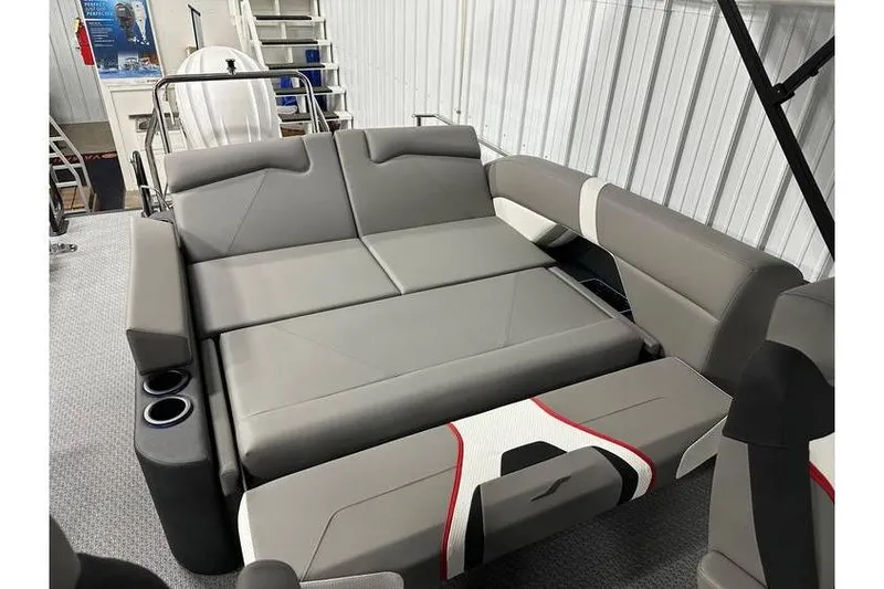 Slide: The Image of 2026 Evotti 723CS boat interior with gray seating and cup holders in a showroom. - 45