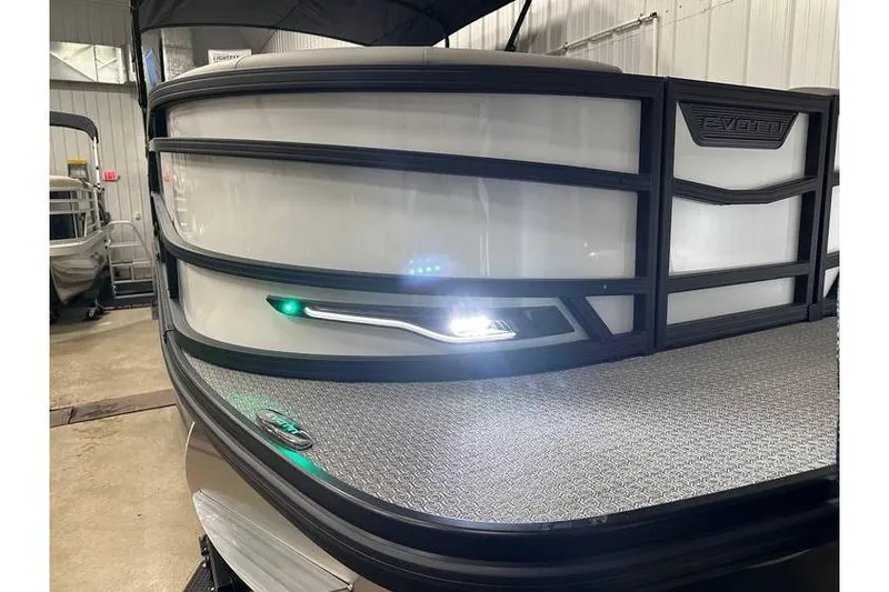 Slide: The Image of 2026 Evotti 723CS boat with sleek design and illuminated deck in a showroom. - 51