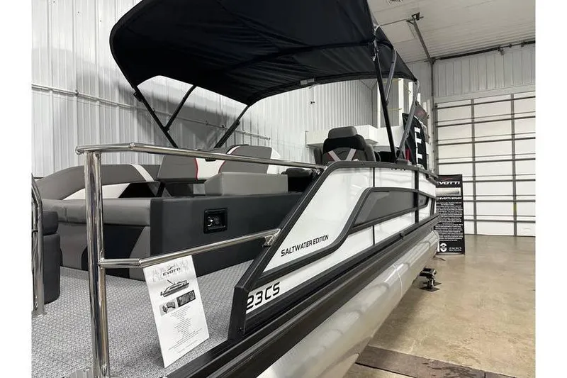 Slide: The Image of 2026 Evotti 723CS Saltwater Edition pontoon boat in showroom with canopy. - 55