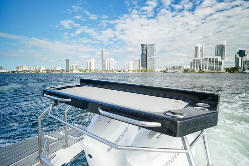 Slide: The Image of 2026 Granfort 370 GTX boat cruising near city skyline under blue sky. - 12