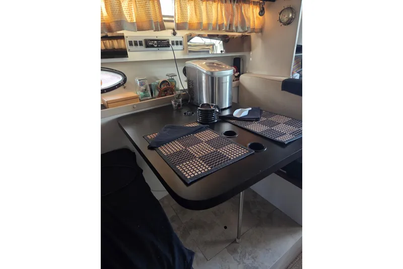 Slide: The Image of Interior of 1988 Wellcraft 3200 St. Tropez with dining table setup. - 11