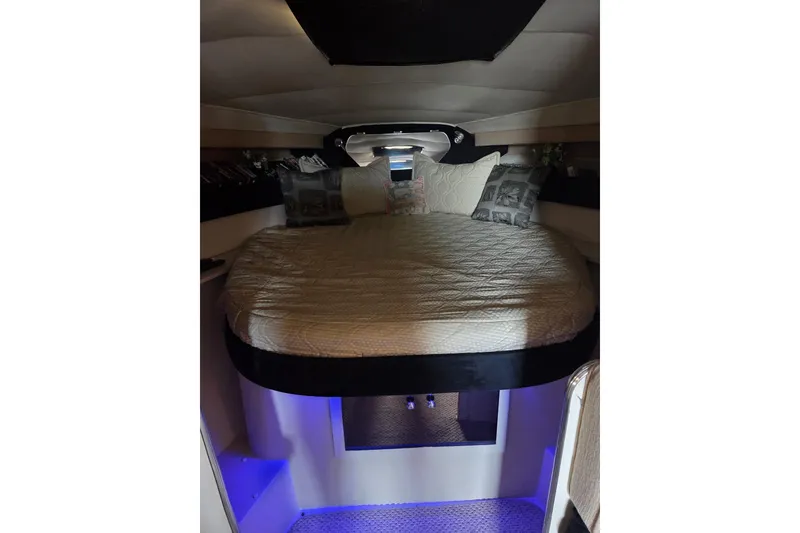 Slide: The Image of Interior cabin of 1988 Wellcraft 3200 St. Tropez with cozy bed and ambient lighting. - 12