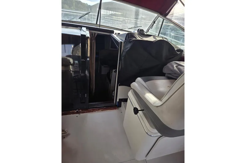 Slide: The Image of 1988 Wellcraft 3200 St. Tropez boat interior with seating and cabin entrance. - 14