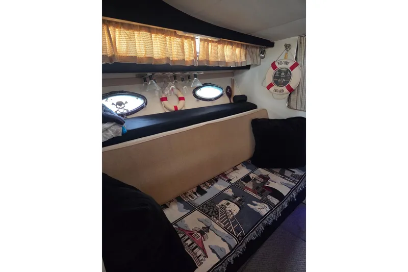 Slide: The Image of Interior of 1988 Wellcraft 3200 St. Tropez with nautical decor and cozy seating. - 15