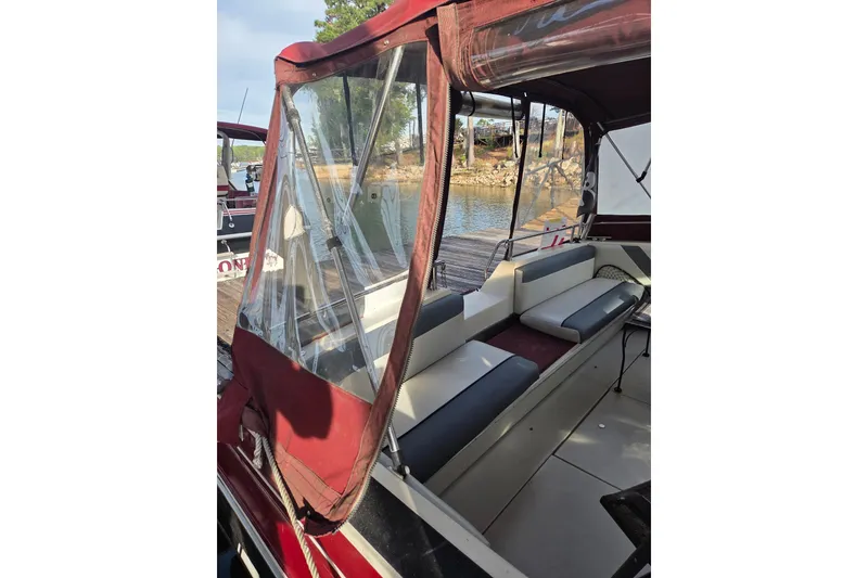 Slide: The Image of 1988 Wellcraft 3200 St. Tropez boat interior with maroon canopy and seating. - 4