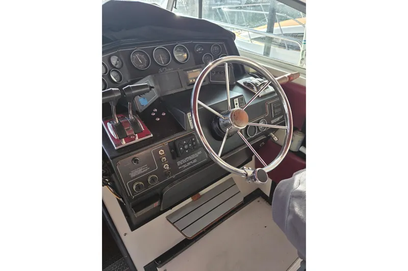 Slide: The Image of 1988 Wellcraft 3200 St. Tropez boat dashboard with steering wheel and control panel. - 7