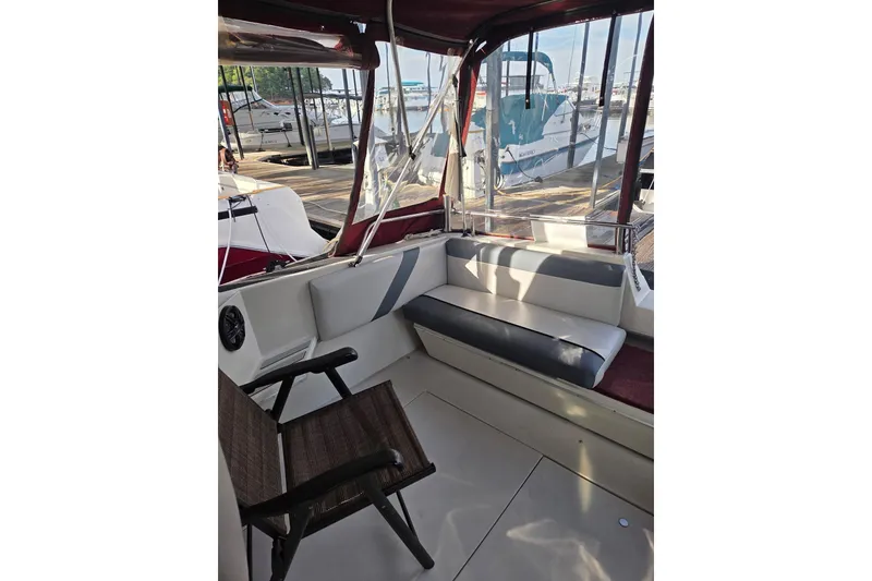 Slide: The Image of 1988 Wellcraft 3200 St. Tropez boat interior with seating and dock view. - 8
