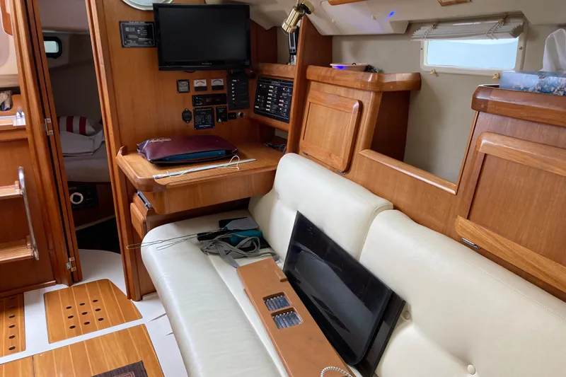 Slide: The Image of Interior of a 1992 Hunter 33.5 sailboat with wooden cabinetry and seating area. - 10