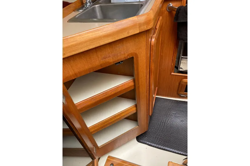 Slide: The Image of 1992 Hunter 33.5 yacht interior with wooden cabinetry and sink. - 14