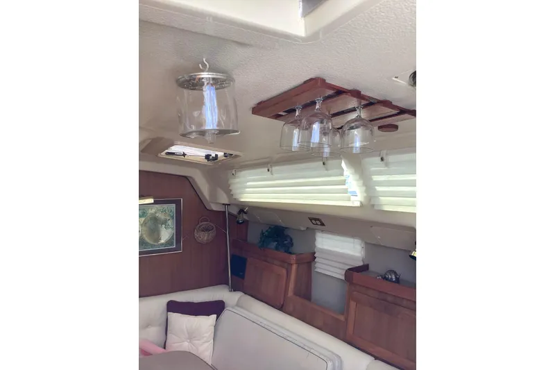 Slide: The Image of Interior of 1992 Hunter 33.5 sailboat with glass holders and cozy seating area. - 17
