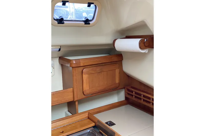Slide: The Image of Interior of 1992 Hunter 33.5 sailboat with wooden cabinetry and paper towel holder. - 20