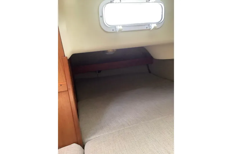 Slide: The Image of Interior cabin of 1992 Hunter 33.5 sailboat with window and wooden paneling. - 24