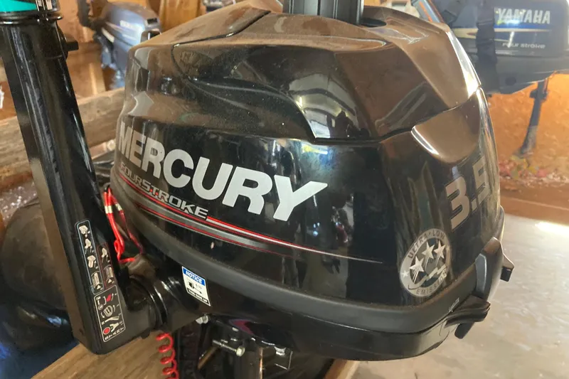 Slide: The Image of Mercury 3.5 outboard motor, four-stroke, in a garage setting, 1992 Hunter model. - 26