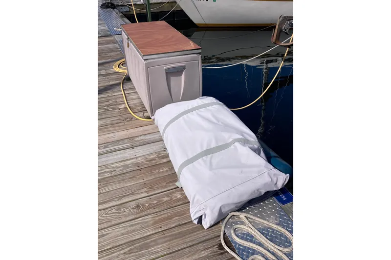 Slide: The Image of Dockside view with storage box and covered item near Hunter 33.5 sailboat, 1992 model. - 27