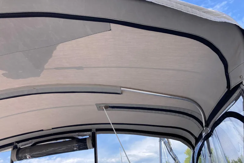 Slide: The Image of Bimini top of 1992 Hunter 33.5 sailboat against blue sky. - 4