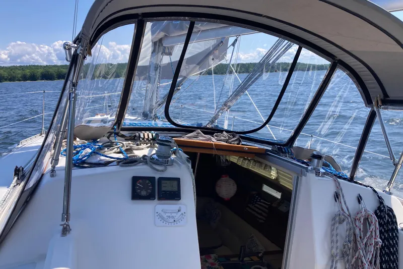 Slide: The Image of 1992 Hunter 33.5 sailboat cockpit with clear canopy, sailing on a sunny day. - 6