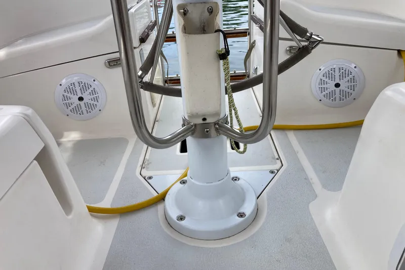 Slide: The Image of Cockpit of a 1992 Hunter 33.5 sailboat with speakers and railing. - 7